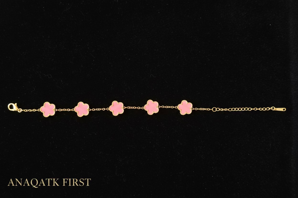 Bracelet with pink flower-shaped charms on a black background, branded 'ANAQATK FIRST'.