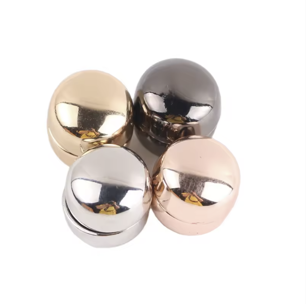 Four metallic balls in gold, silver, and rose gold on a white background