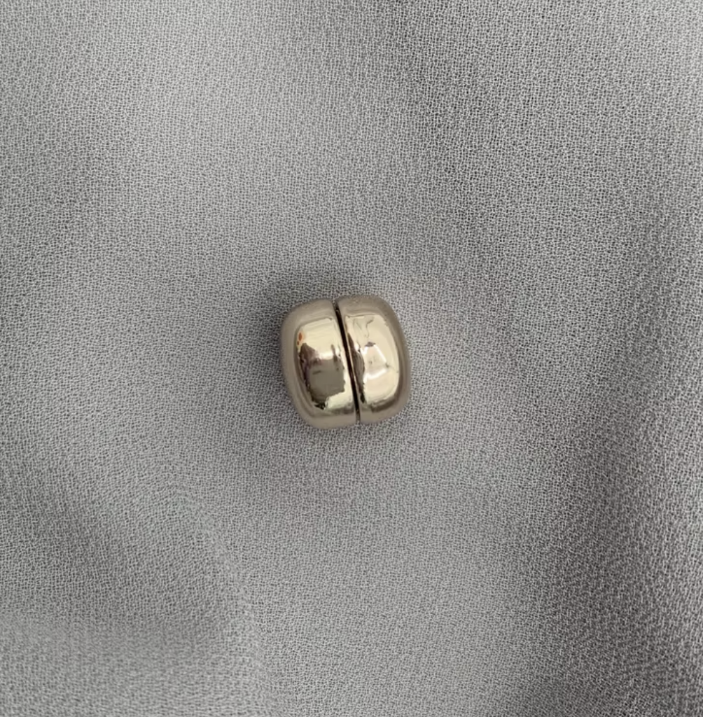 Silver bead on a gray fabric background