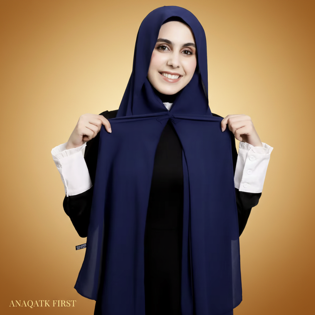 Woman wearing a navy blue hijab with a white background