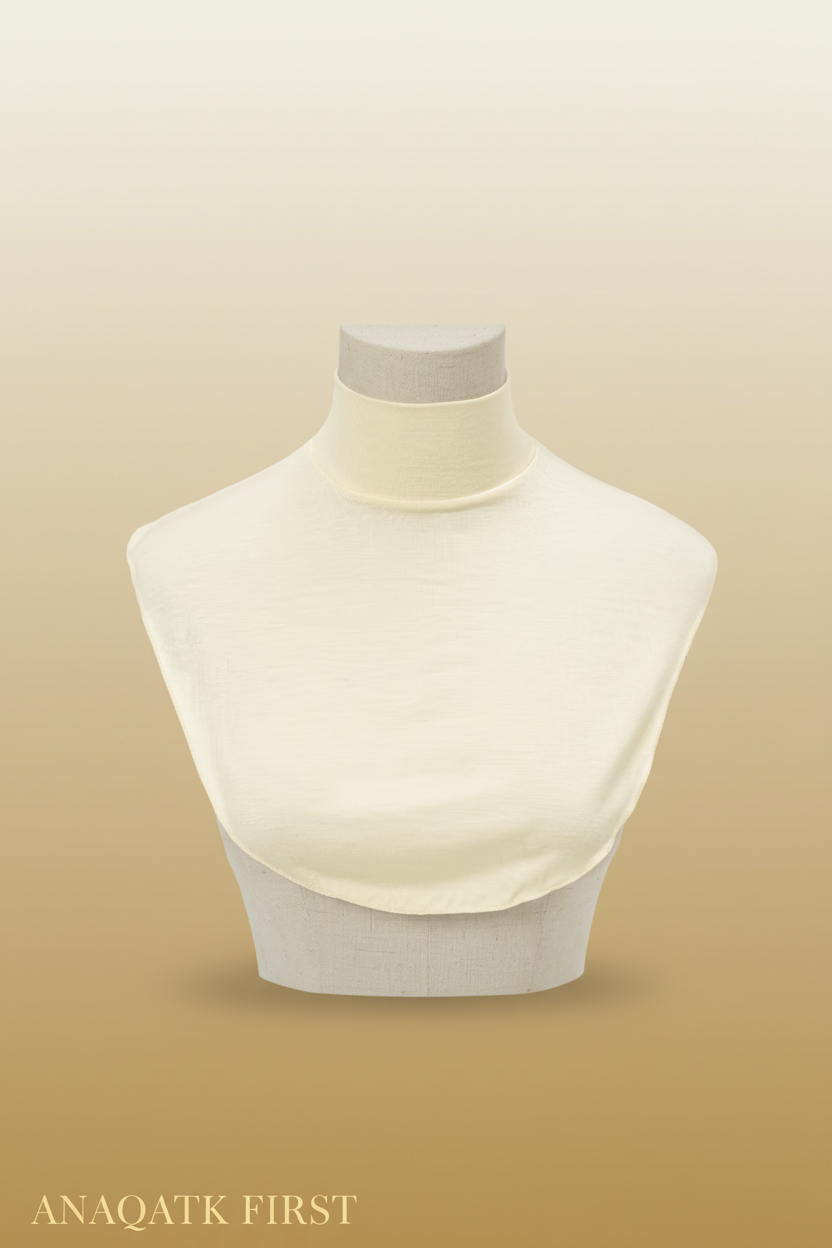 Beige high-neck top on a mannequin against a light gray background