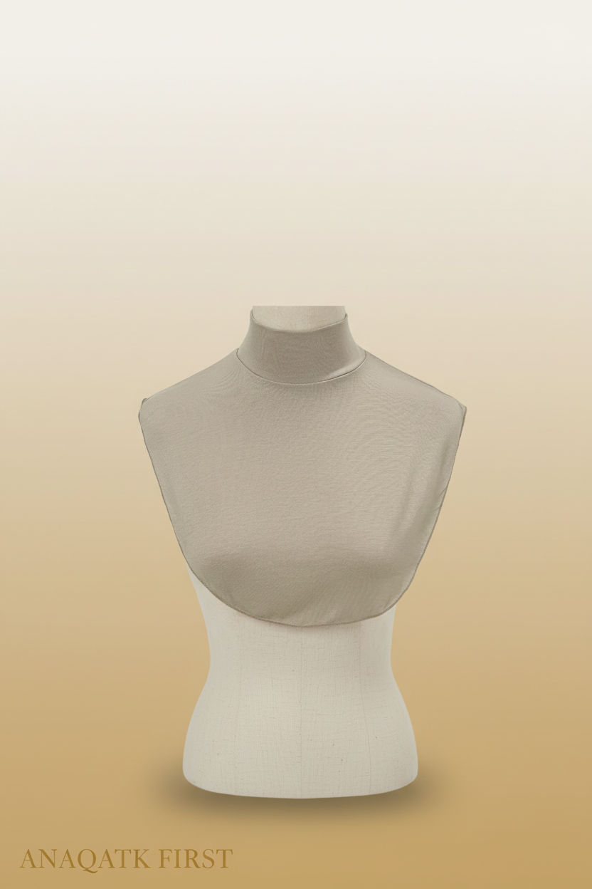 Beige turtleneck sweater on a mannequin torso against a white background