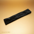 Black headband on a textured white surface