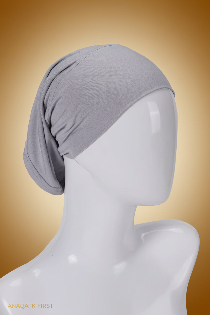 Gray headscarf on a mannequin head against a white background