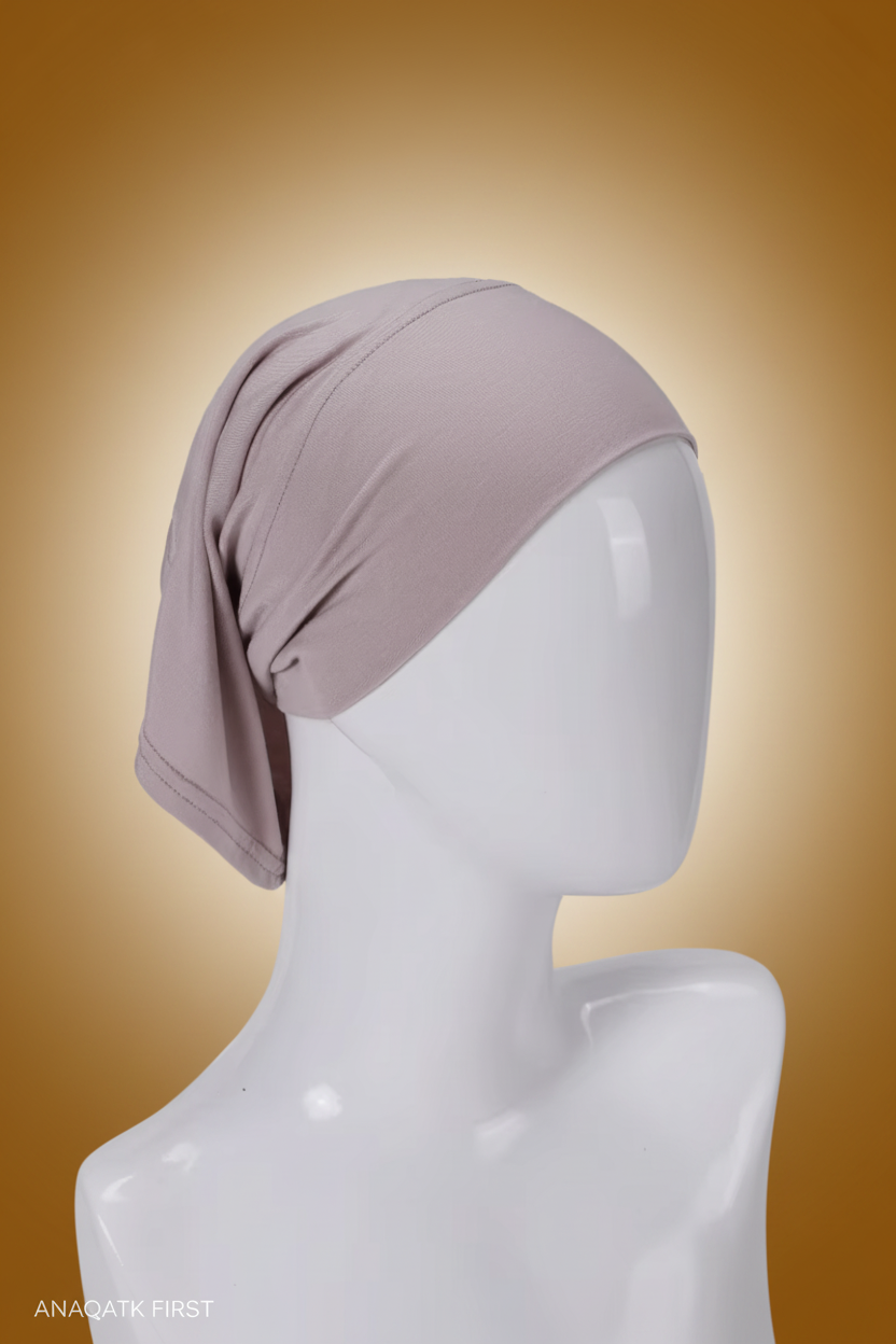 Mauve headscarf on a mannequin head against a white background