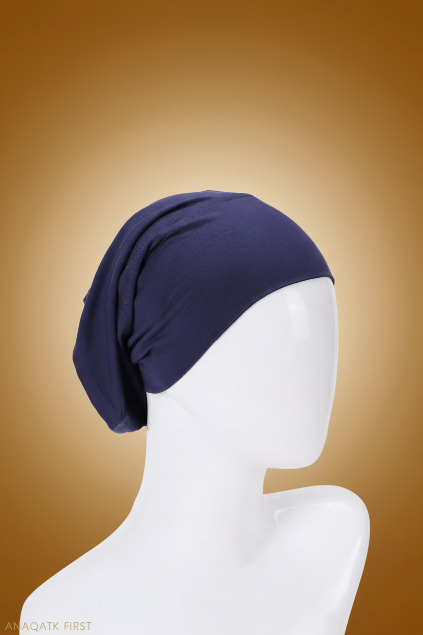 Navy blue headscarf on a mannequin head against a white background