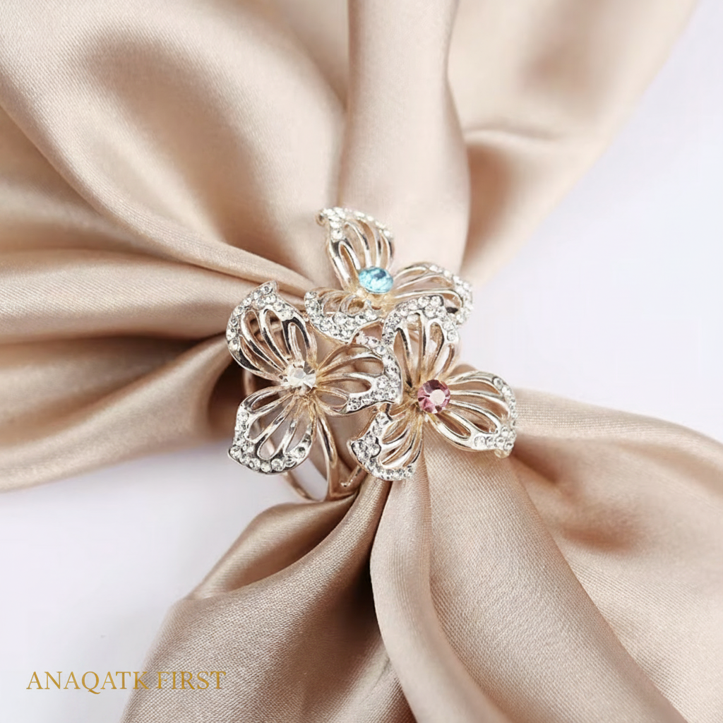 Decorative brooch with gemstones on a beige fabric background