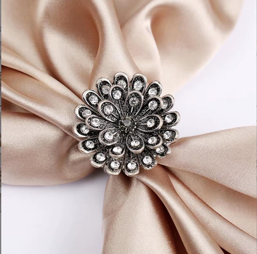 Decorative brooch on a folded beige fabric
