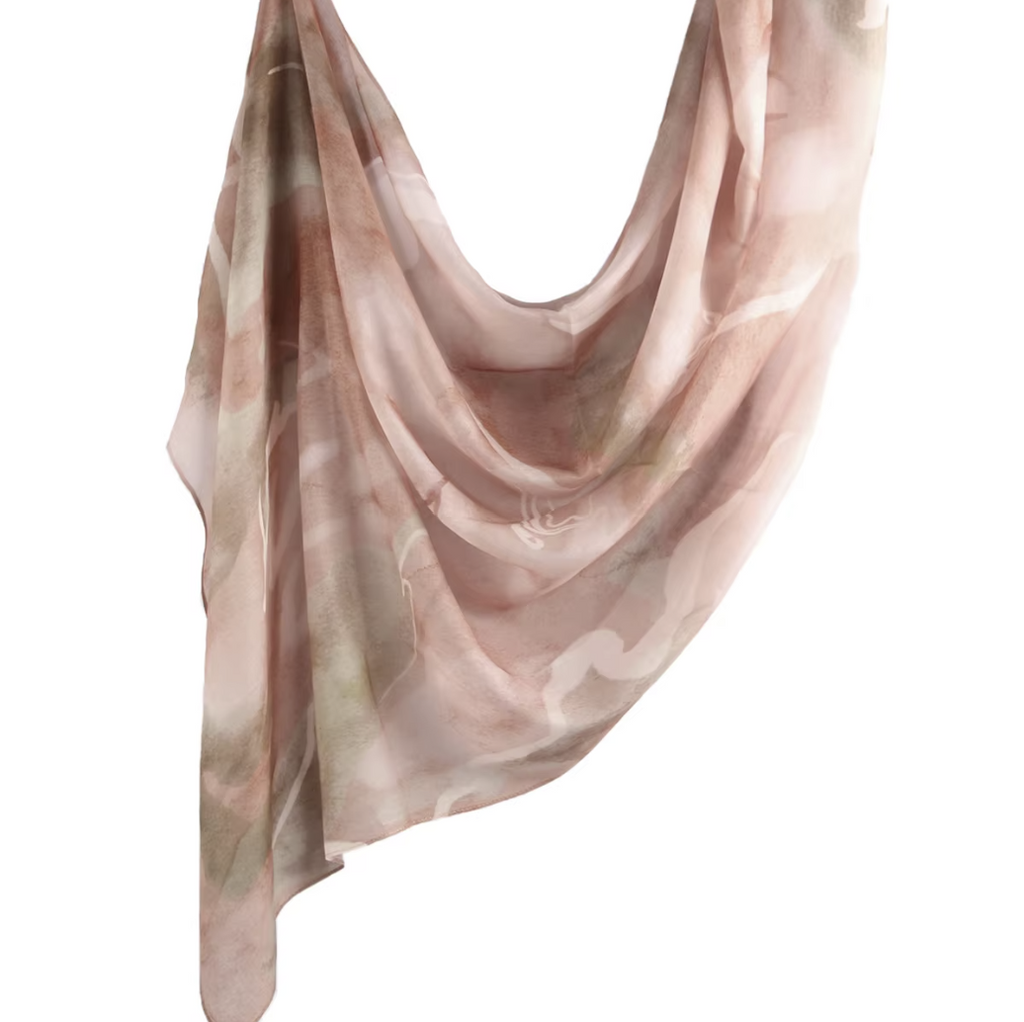 Pink and beige patterned scarf on a white background