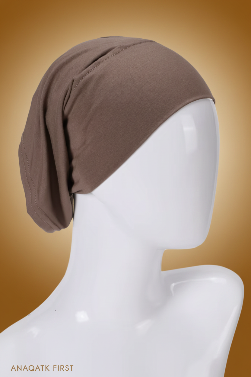 Brown headscarf on a mannequin head against a white background